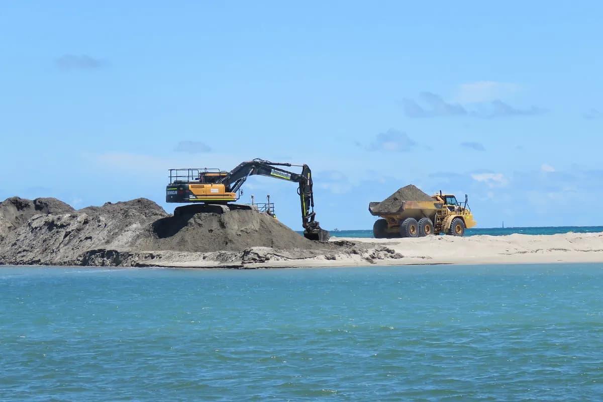 Excavator loading quarry aggregates